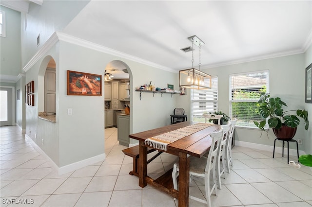 955 Hidden Terrace Rd, Naples, FL 34104 - dining room featuring light tile patterned flooring, arched walkways, ornamental molding, baseboards, and a chandelier