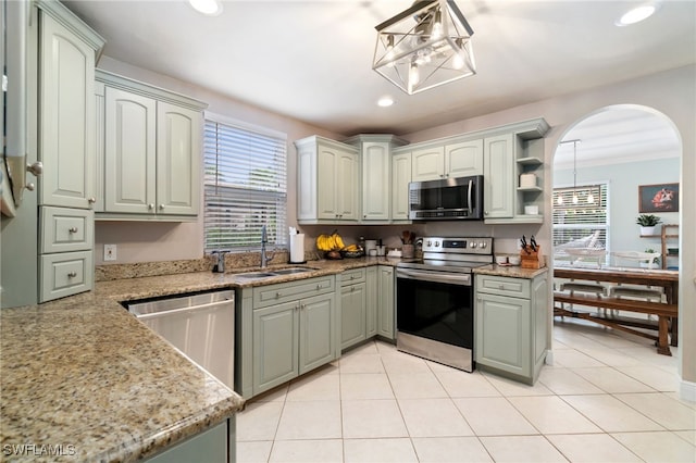 955 Hidden Terrace Rd, Naples, FL 34104 - kitchen featuring appliances with stainless steel finishes, a sink, recessed lighting, light stone counters, and decorative light fixtures