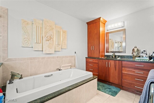 4226 Yarmouth Ct, North Fort Myers, FL 33903 - full bathroom featuring vanity, a tub with jets, and tile patterned floors
