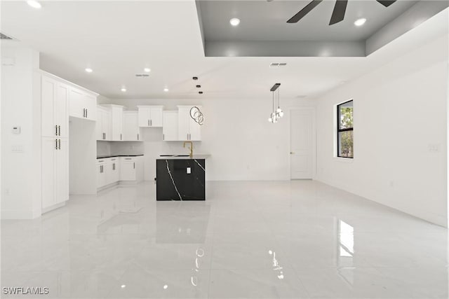 1015 Gerald Ave, Lehigh Acres, FL 33936 - unfurnished living room with ceiling fan, recessed lighting, baseboards, a sink, and a raised ceiling