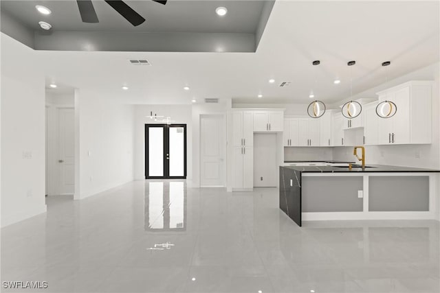 1015 Gerald Ave, Lehigh Acres, FL 33936 - kitchen with a sink, recessed lighting, light tile patterned floors, white cabinets, and french doors