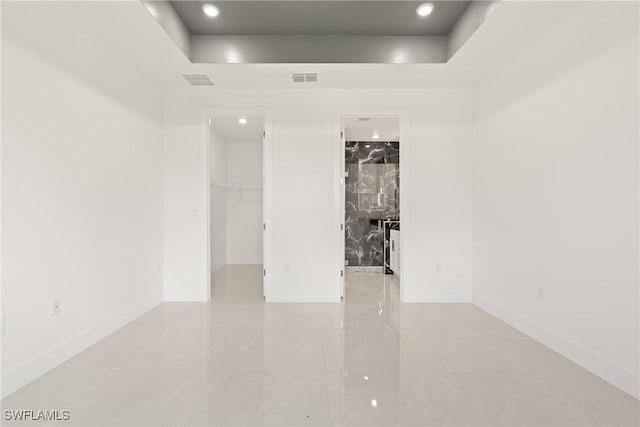 1015 Gerald Ave, Lehigh Acres, FL 33936 - empty room featuring baseboards, a raised ceiling, and recessed lighting
