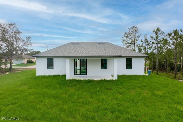 1015 Gerald Ave, Lehigh Acres, FL 33936 - back of house featuring stucco siding, a patio, a lawn, and a shingled roof