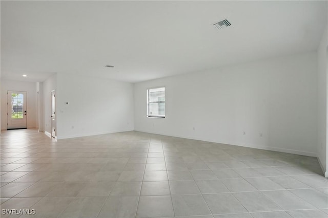 13952 Hunter Oak Dr, Fort Myers, FL 33913 - empty room with light tile patterned floors, healthy amount of natural light, recessed lighting, and baseboards