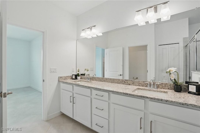 13952 Hunter Oak Dr, Fort Myers, FL 33913 - full bathroom with double vanity, tile patterned flooring, a shower with door, and baseboards
