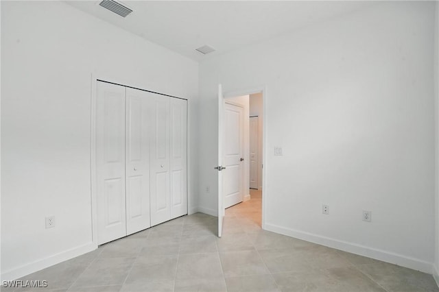 13952 Hunter Oak Dr, Fort Myers, FL 33913 - unfurnished bedroom featuring light tile patterned floors, baseboards, and a closet