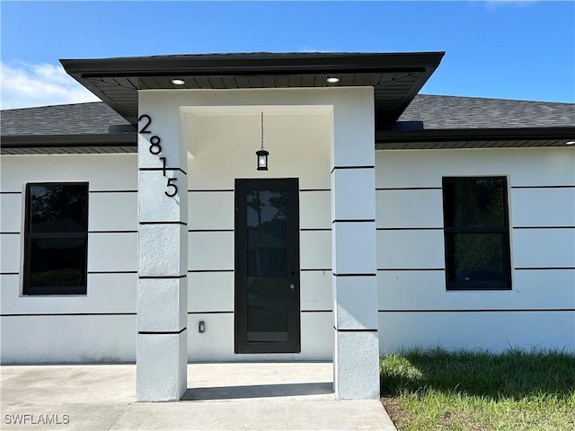 2815 4th St SW, Lehigh Acres, FL 33976 - doorway to property featuring a shingled roof