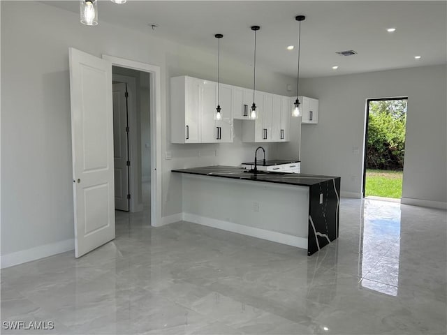 2815 4th St SW, Lehigh Acres, FL 33976 - kitchen featuring dark countertops, baseboards, and recessed lighting