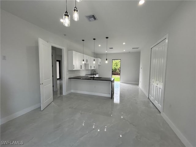 2815 4th St SW, Lehigh Acres, FL 33976 - kitchen with dark countertops, open floor plan, white cabinets, baseboards, and recessed lighting