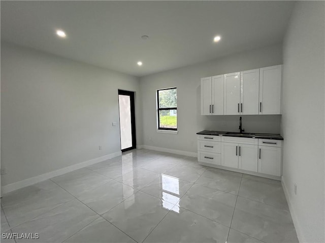 2815 4th St SW, Lehigh Acres, FL 33976 - empty room featuring recessed lighting, a sink, baseboards, and light marble finish floors