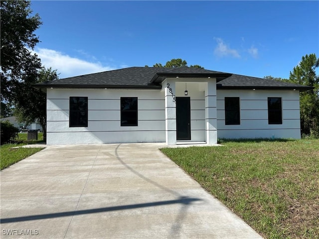 2815 4th St SW, Lehigh Acres, FL 33976 - view of front of property with roof with shingles and a front yard