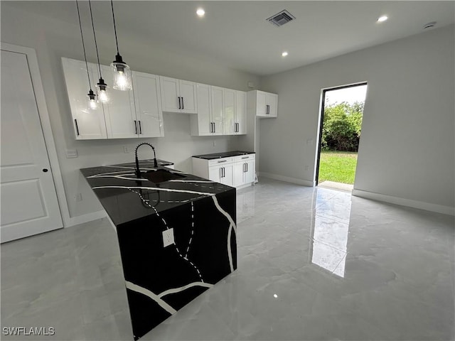 2815 4th St SW, Lehigh Acres, FL 33976 - kitchen featuring baseboards, white cabinetry, recessed lighting, pendant lighting, and light marble finish flooring
