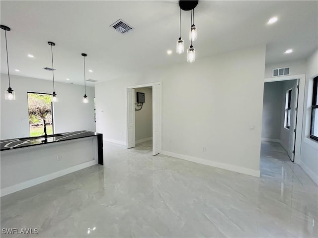 2815 4th St SW, Lehigh Acres, FL 33976 - unfurnished living room with recessed lighting, baseboards, and light marble finish flooring