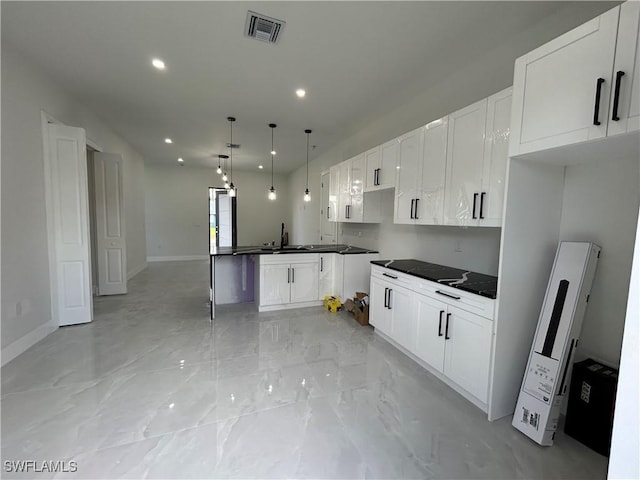 2815 4th St SW, Lehigh Acres, FL 33976 - kitchen with recessed lighting, a sink, white cabinetry, dark countertops, and hanging light fixtures