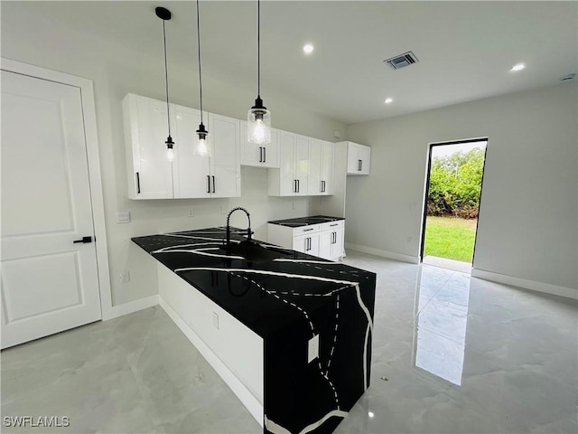 2815 4th St SW, Lehigh Acres, FL 33976 - kitchen featuring finished concrete flooring, baseboards, white cabinets, dark countertops, and recessed lighting