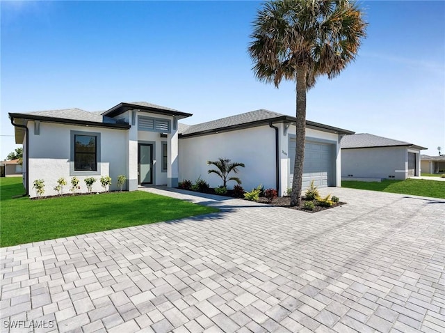 3034 Chiquita Blvd N, Cape Coral, FL 33993 - prairie-style house featuring decorative driveway, a garage, stucco siding, and a front lawn