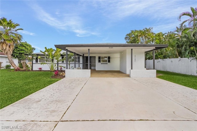 5127 SW 3rd Ave, Cape Coral, FL 33914 - view of front of property with driveway, an attached carport, and a sunroom