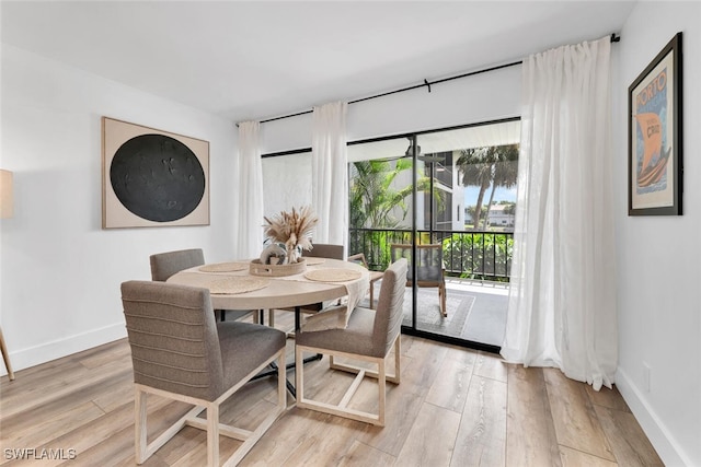 3030 Binnacle Dr Unit 206, Naples, FL 34103 - dining space featuring light wood-style floors and baseboards
