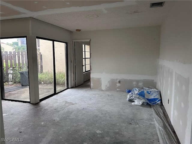 632 SE 12th Ct Unit 12, Cape Coral, FL 33990 - empty room featuring concrete floors and a textured ceiling