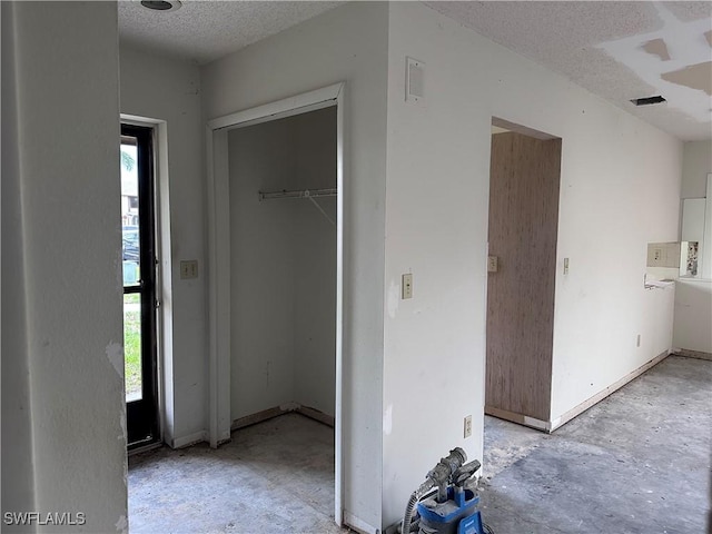 632 SE 12th Ct Unit 12, Cape Coral, FL 33990 - unfurnished bedroom featuring concrete floors, a textured ceiling, and a closet