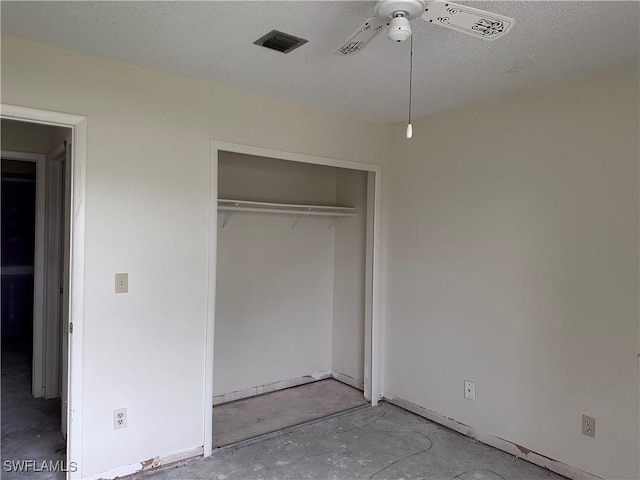 632 SE 12th Ct Unit 12, Cape Coral, FL 33990 - unfurnished bedroom featuring concrete flooring, a closet, a ceiling fan, and a textured ceiling