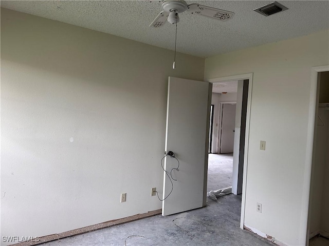632 SE 12th Ct Unit 12, Cape Coral, FL 33990 - unfurnished bedroom featuring concrete flooring, a textured ceiling, ceiling fan, and baseboards