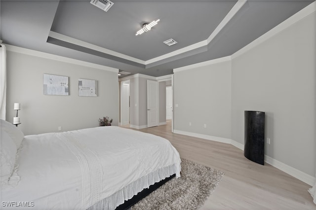 4654 Kensington Cir, Naples, FL 34119 - bedroom with a tray ceiling, wood finished floors, and baseboards
