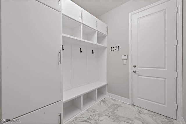 4654 Kensington Cir, Naples, FL 34119 - mudroom with light marble finish flooring and baseboards