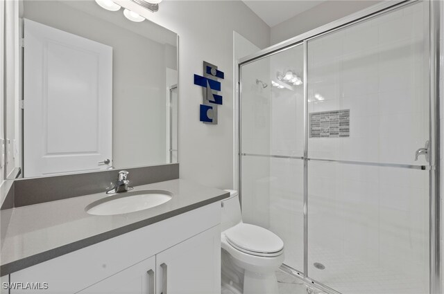 4654 Kensington Cir, Naples, FL 34119 - bathroom featuring vanity, a stall shower, and toilet