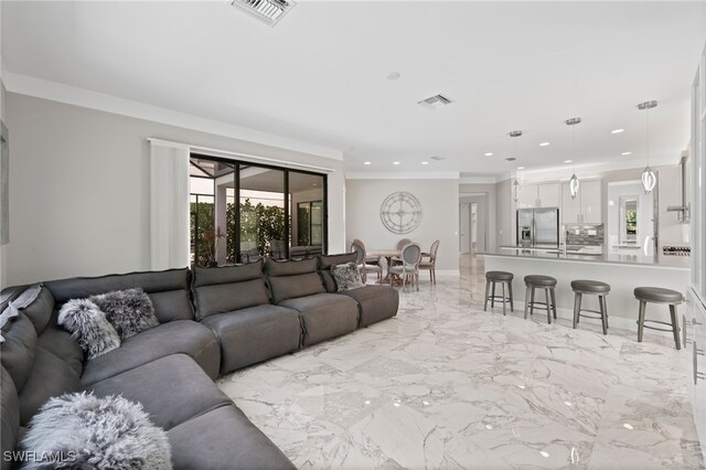 4654 Kensington Cir, Naples, FL 34119 - living room with plenty of natural light, recessed lighting, crown molding, and light marble finish flooring