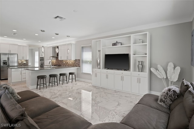 4654 Kensington Cir, Naples, FL 34119 - living area with light marble finish floors, plenty of natural light, recessed lighting, and baseboards
