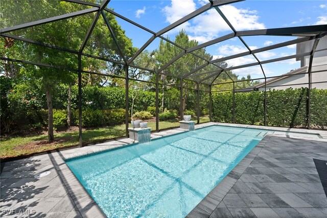 4654 Kensington Cir, Naples, FL 34119 - outdoor pool with a patio and glass enclosure