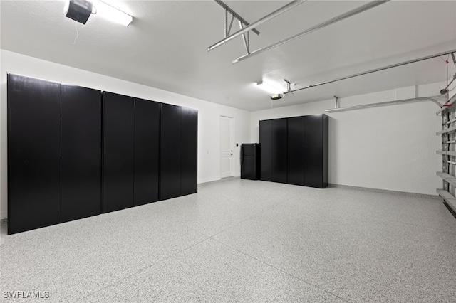 4654 Kensington Cir, Naples, FL 34119 - garage featuring a garage door opener