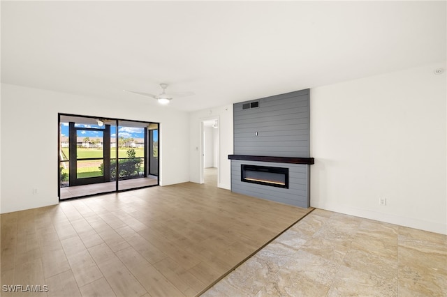 16290 Kelly Cove Dr Unit 253, Fort Myers, FL 33908 - unfurnished living room featuring a large fireplace and a ceiling fan