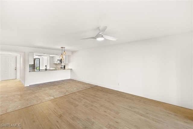 16290 Kelly Cove Dr Unit 253, Fort Myers, FL 33908 - unfurnished living room featuring light wood-style flooring, a ceiling fan, and baseboards