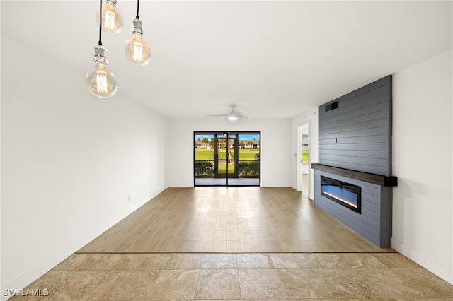16290 Kelly Cove Dr Unit 253, Fort Myers, FL 33908 - unfurnished living room with a large fireplace, ceiling fan, and baseboards