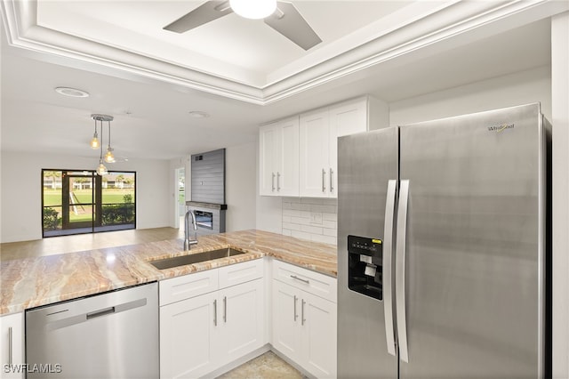 16290 Kelly Cove Dr Unit 253, Fort Myers, FL 33908 - kitchen featuring appliances with stainless steel finishes, a sink, light stone countertops, a ceiling fan, and white cabinets