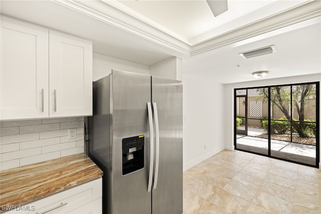 16290 Kelly Cove Dr Unit 253, Fort Myers, FL 33908 - kitchen featuring stainless steel refrigerator with ice dispenser, tasteful backsplash, white cabinetry, baseboards, and light stone counters