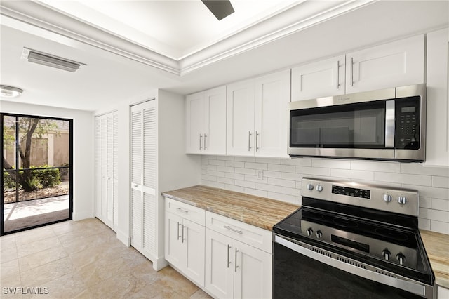 16290 Kelly Cove Dr Unit 253, Fort Myers, FL 33908 - kitchen featuring stainless steel appliances, backsplash, light countertops, and white cabinets