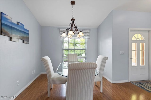 608 SW 43rd Ter, Cape Coral, FL 33914 - dining area featuring a chandelier and wood finished floors