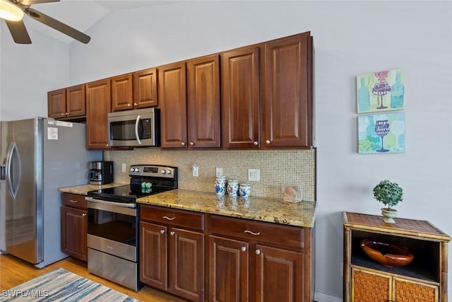 608 SW 43rd Ter, Cape Coral, FL 33914 - kitchen featuring stainless steel appliances, ceiling fan, decorative backsplash, light wood-style flooring, and lofted ceiling