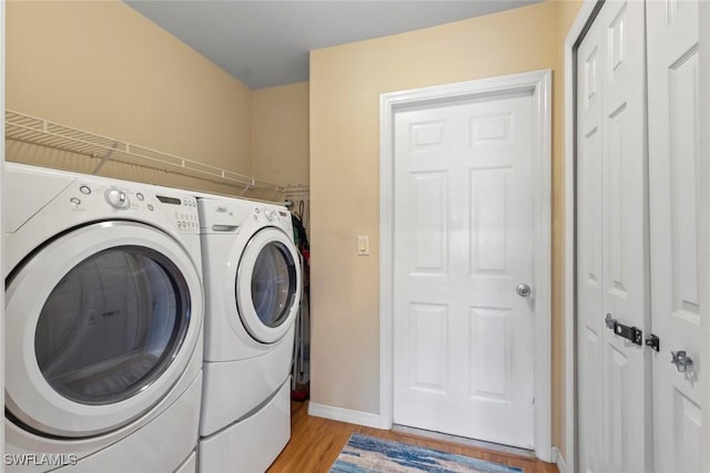 608 SW 43rd Ter, Cape Coral, FL 33914 - laundry area featuring washer and dryer and light wood-style floors