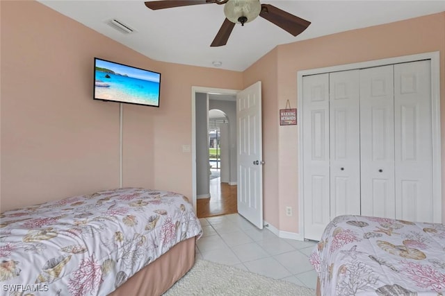 608 SW 43rd Ter, Cape Coral, FL 33914 - bedroom with light tile patterned floors, arched walkways, a ceiling fan, and a closet