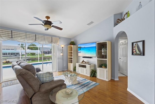 608 SW 43rd Ter, Cape Coral, FL 33914 - living area with ceiling fan, arched walkways, wood finished floors, and vaulted ceiling