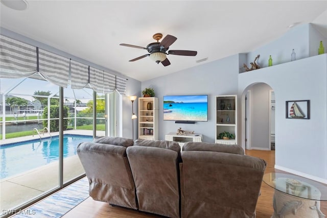 608 SW 43rd Ter, Cape Coral, FL 33914 - living area featuring arched walkways, ceiling fan, wood finished floors, and lofted ceiling