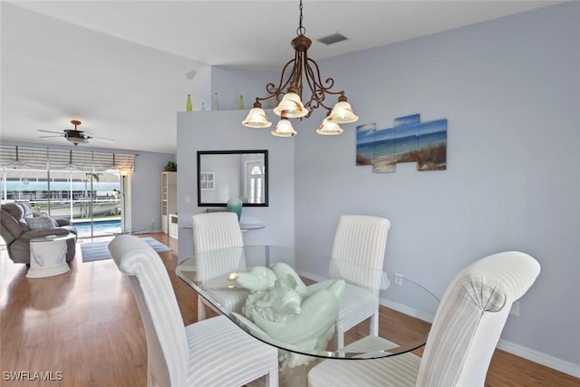 608 SW 43rd Ter, Cape Coral, FL 33914 - dining room with wood finished floors, ceiling fan, and a chandelier