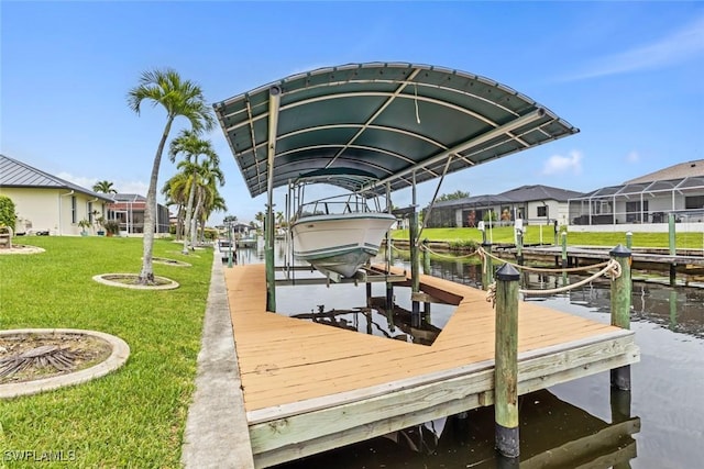 608 SW 43rd Ter, Cape Coral, FL 33914 - dock area with boat lift, a residential view, a lawn, and a water view