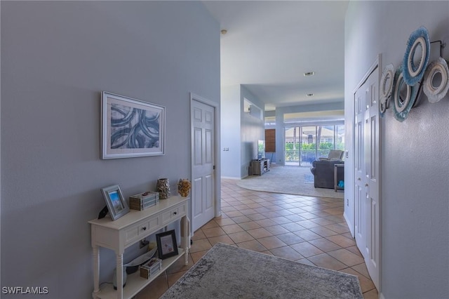 19372 Silver Oak Dr, Estero, FL 33967 - hallway featuring light tile patterned flooring and baseboards