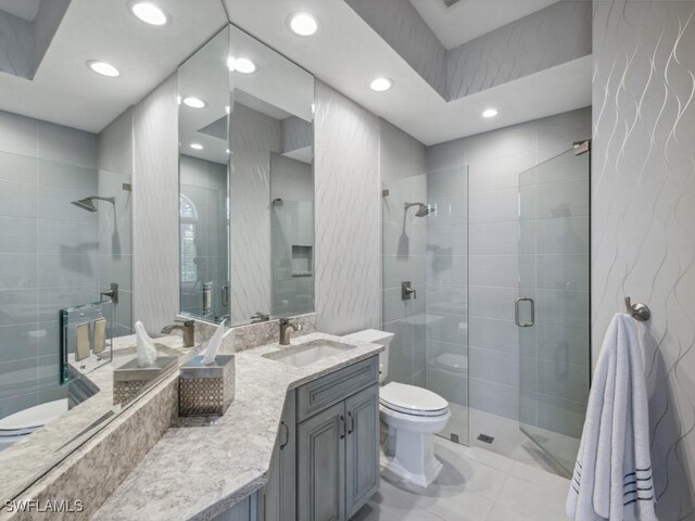 14822 Bellezza Ln, Naples, FL 34110 - bathroom with toilet, a shower stall, vanity, recessed lighting, and tile walls