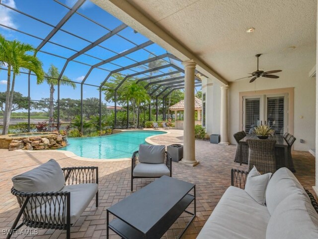 14822 Bellezza Ln, Naples, FL 34110 - view of pool featuring outdoor lounge area, a patio, a pool with connected hot tub, and a ceiling fan